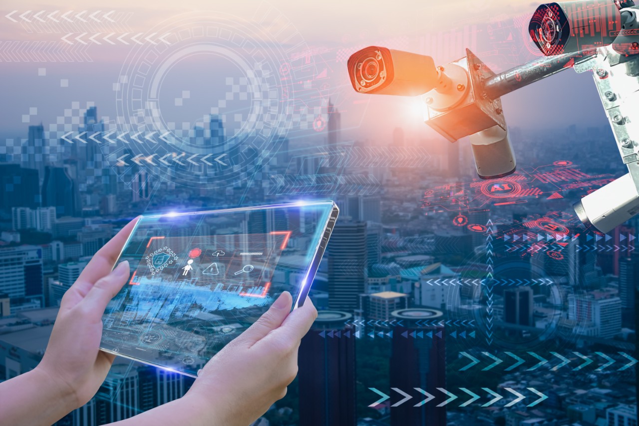 Woman hand holding futuristic tablet device,to monitor safety and memorize people's information and behavior in city,concept cctv camera intelligent of artificial intelligence in urban for safety